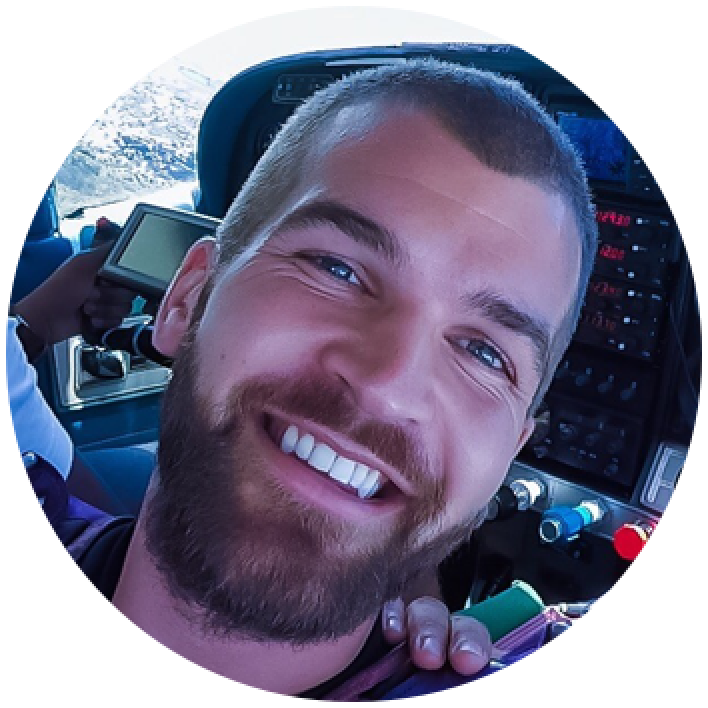 Smiling young man with a beard. 