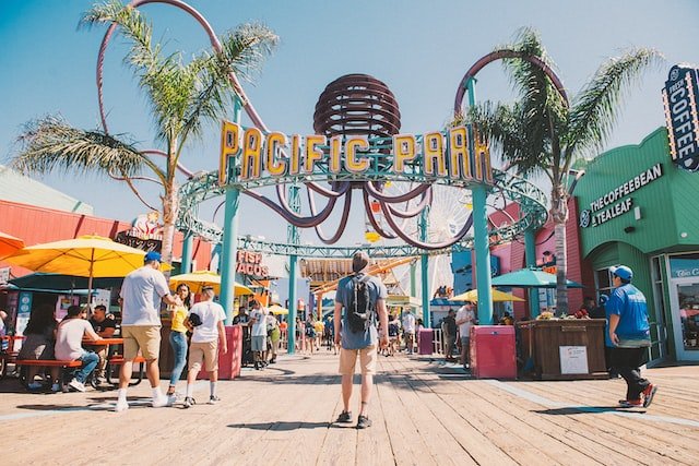 colorful amusement park entrance with palm trees