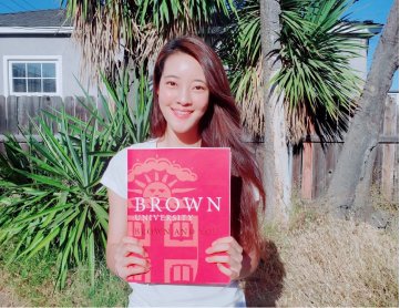 Young woman holding a Brown University photo