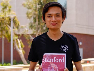 Young man holding a Stanford University poster